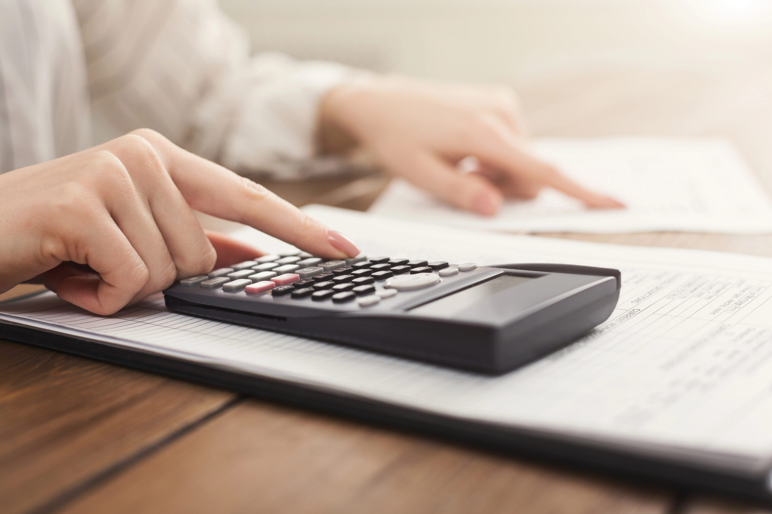 Homeowner calculating Florida property taxes using a financial calculator