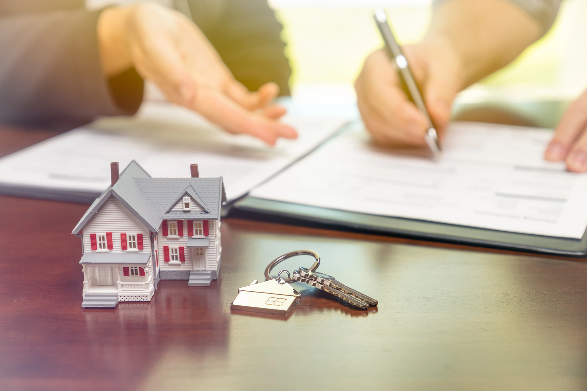 Real estate closing documents and house keys in Florida